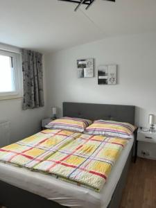 a bed with a colorful comforter in a bedroom at Ferienhaus Schiemel in Altmünster