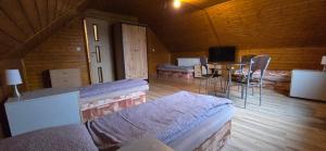 a room with beds and a table in a cabin at Villa MarViK in Lučenec