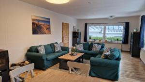 a living room with two couches and a table at Ferienwohnung Dons in Grömitz