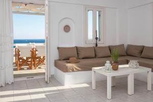 a living room with a couch and a table at Cleopatra Seaside Homes in Piso Livadi
