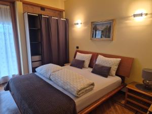 a bedroom with a bed with pillows on it at Il Rosone in Tirano