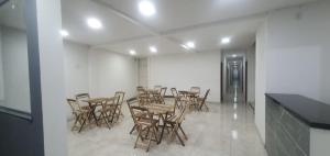 a group of tables and chairs in a room at Hotel Ypê in Floriano