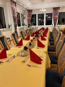 a conference room with a long table with red napkins at Donau-Rad-Hotel Wachauerhof in Marbach an der Donau +16 photos