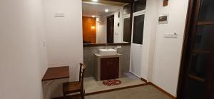 a small bathroom with a sink and a mirror at Elite Nest in Ahangama