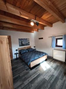 a bedroom with a bed in a room with wooden ceilings at Apartment Le 1739 in La Coste