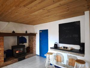 a living room with a brick fireplace and a blue door at Apartment Le 1739 in La Coste