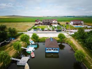 an aerial view of a house with boats in the water at Danubiu Resort in Murighiol
