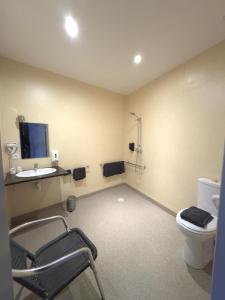 a room with a bathroom with a toilet and a sink at Hôtel le midi in Montaigu-de-Quercy