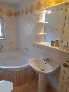a bathroom with a sink and a bath tub at Kuća za odmor Silver pine in Ogulin +38 photos