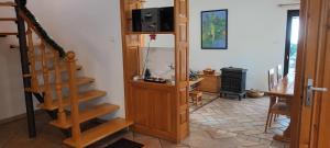 a living room with a staircase and a television at Kuća za odmor Silver pine in Ogulin