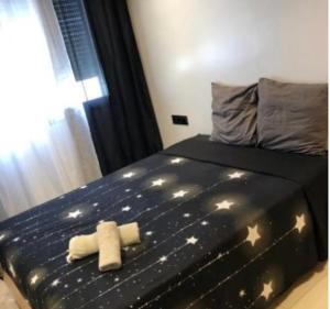 a bedroom with a bed with two towels on it at La corniche in Kenitra
