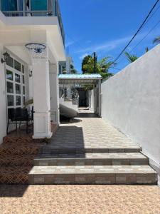 a white house with a basketball hoop on the porch at Villa 3D Grand baie Pereybere in Pereybere +23 photos