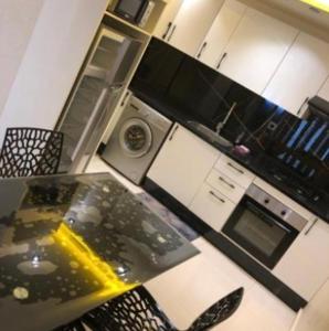 a kitchen with a table and a stove top oven at La corniche in Kenitra