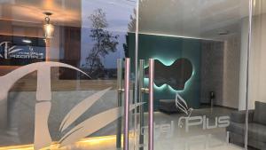 a glass door with an apple logo on it at Hotel Azomali plus in Tula de Allende