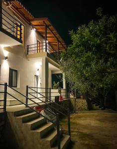 a house with stairs leading up to it at night at Milo's Villa in Dhërmi