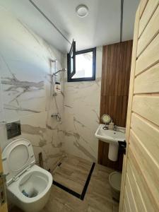 a bathroom with a toilet and a sink at issac in Monastir +19 photos