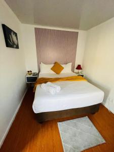 a bedroom with a large bed in a room at Kay's Guest House in Kraaifontein