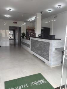 a lobby of a hotel with a reception counter at Hotel Zagonel in Chapecó