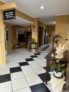 a lobby with a black and white checkered floor at Pousada 2 Rios Comfort in Barra do Garças