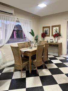a dining room with a table and chairs on a checkered floor at Pousada 2 Rios Comfort in Barra do Garças +72 photos
