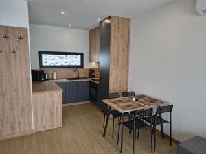 a kitchen with a table and chairs in a room at Domki nad jeziorem in Dobczyce