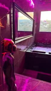 a purple bathroom with a sink and a window at Nuit D Or LoveRoom in Bellegarde-sur-Valserine +27 photos