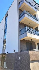 a building with balconies on the side of it at Upendo Apartment in Vrnjačka Banja