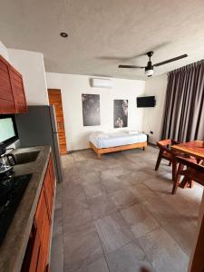 a living room with a bed and a table at condo pacha tulum in Tulum