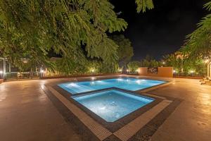 a swimming pool in a yard at night at Tiger Woods Ranthambore in Sawāi Mādhopur