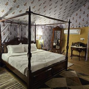a bedroom with a canopy bed and a piano at Tiger Woods Ranthambore in Sawāi Mādhopur