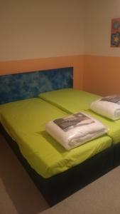 a bedroom with two beds with lime green sheets at Bauernwohnung in Waldmünchen