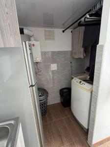 a small kitchen with a sink and a refrigerator at Descansa, comodidad y confort in Manizales +18 photos