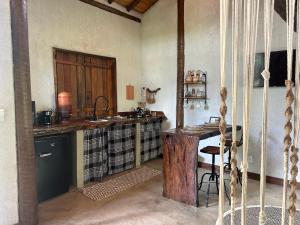 a kitchen with a counter and a table in a room at loft Ágata in Brumadinho