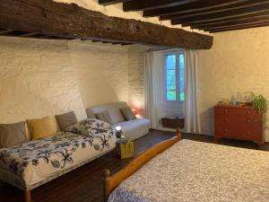 a bedroom with two beds and a dresser and a window at Chez Marie Roulotte in Pontfarcy