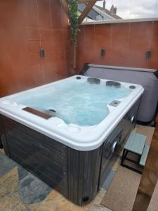 a jacuzzi tub sitting in a room with at Le Baiser Doré in Sainte-Marie-aux-Chênes +11 photos
