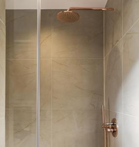 a shower stall with a glass shower door at Anasa Hotel Athens in Athens