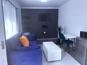 a living room with a blue couch and a table at SA Guest House in Roodepoort
