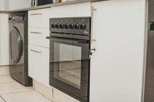 a kitchen with a stove and a refrigerator at Ballito Seasons in Ballito