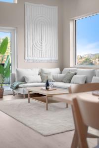 a living room with a couch and a coffee table at Sunset Bay Penthouse in Kristiansand