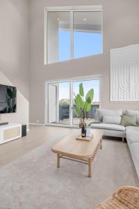 a living room with a couch and a coffee table at Sunset Bay Penthouse in Kristiansand