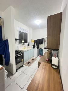 a kitchen with a wooden counter top in a room at Ap Hostel For You in Serra