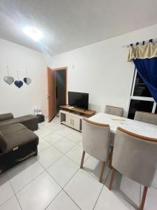 a living room with a table and a couch at Ap Hostel For You in Serra