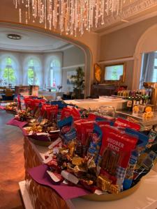 a buffet line with many bags of chips and candy at Hotel & Restaurant Bellevue Schmölln in Schmölln