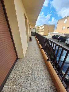 a balcony of a building with cars parked in a parking lot at Appartement confortable à Propriano avec balcon in Propriano