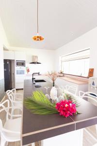 a kitchen with a table with flowers on it at Ataku'a Lodge in Hakamui