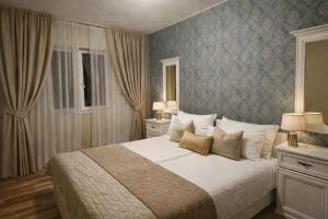 a bedroom with a large bed with pillows at Zadar Kali Booking Franov Residence on island Ugljan with the pool, BBQ and beautiful sea-view! in Kali