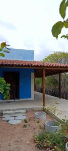 a blue and white building with a wooden roof at Casa Para Carnaval de Aracati in Aracati