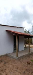 a small white building with a red roof at Casa Para Carnaval de Aracati in Aracati
