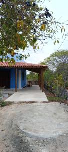 a pavilion with a picnic table in front of a building at Casa Para Carnaval de Aracati in Aracati