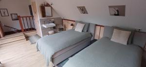 a bedroom with two beds and a sink in it at Bed & Breakfast Appenseweg in Voorst +15 photos